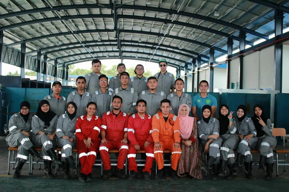 Analyn with welding colleagues and trainees, signing off